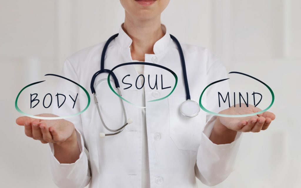 Doctor holding words Body/Mind/Soul